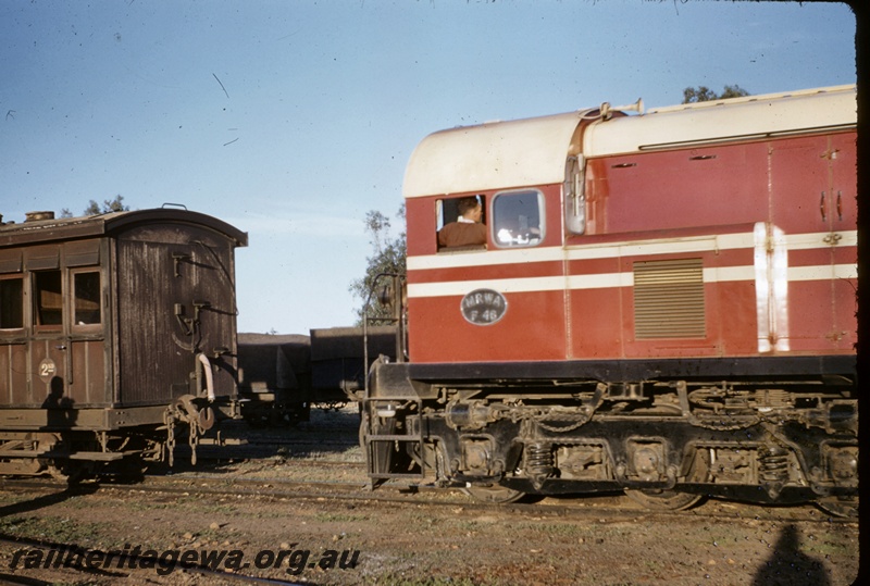 T04936
MRWA diesel loco  F class 46,  side view of drivers cab end, part of side and end view of MRWA JA class carriage in a worn  MRWA brown livery, cutting off Easter special to be worked to Geraldton by X class loco, Walkaway, MR line
