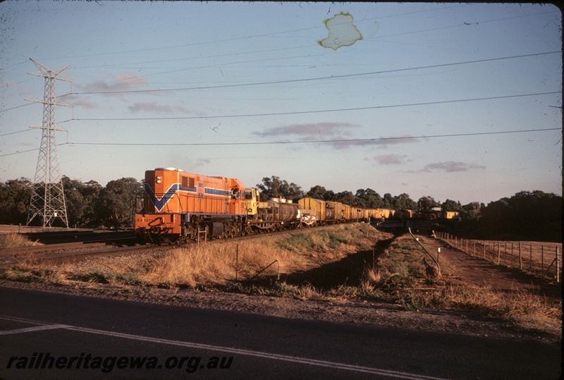 T04955
DA class 1572, on No 18 freighter including flat bed wagons, tanker wagons, and vans, crossing culvert, power line pylon, near Woodbridge, ER line
