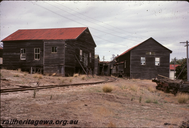 T04995
Millars workshops, wooden buildings with red iron roofs, single track, flat trucks, view from track level
