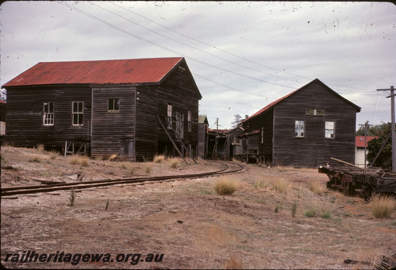 T04995
Millars workshops, wooden buildings with red iron roofs, single track, flat trucks, view from track level
