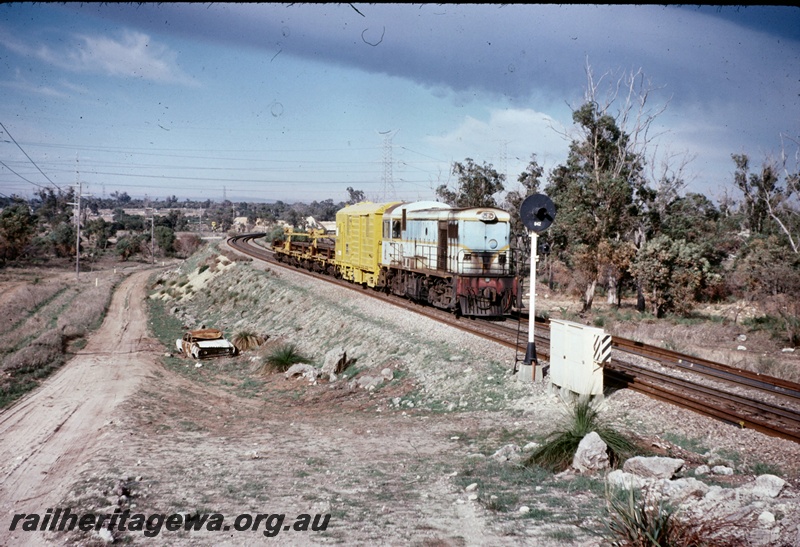 T05090
H class 1, on work train comprising van and wagons, light signal, near Cockburn, side and front view
