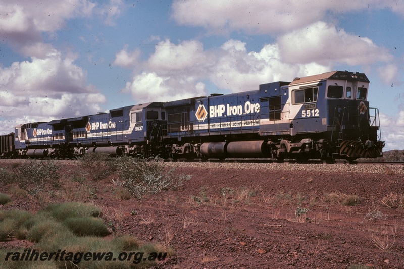 T05170
BHP Iron Ore (BHPIO) C36-7M class 5512 leads 2 other unidentified locomotives hauling an empty iron ore train between Newman and Port Hedland.
