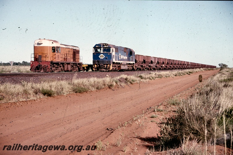 T05184
BHP Iron Ore (BHPIO) Goldsworthy Joint Venture GML10 class 10 passing B class 2 between Finucane Island and Goldsworthy.
