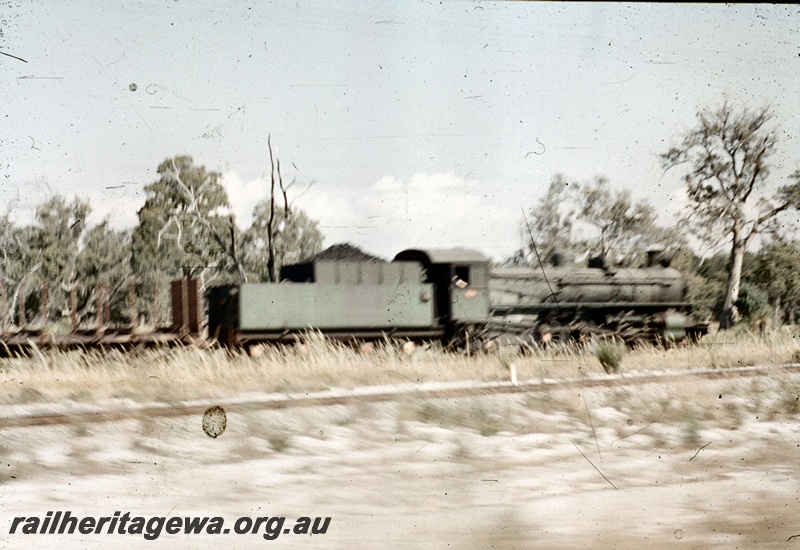 T05225
PM class loco, on goods train including empty flat wagons with bolsters, Mundijong Junction, SWR line, rear and side view 
