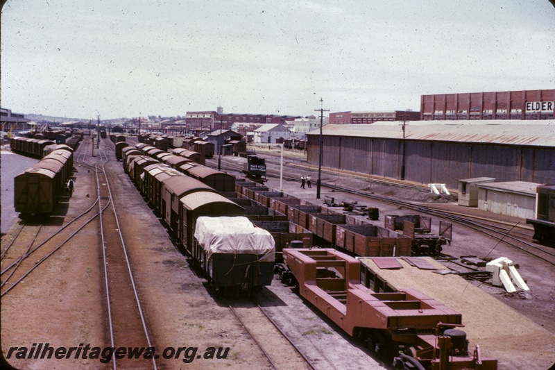 T05245
Fremantle goods yard, various rakes of vans and wagons including QY class 2300 well wagon, cranes, warehouses, pedestrian overpass, loading gauge, loading ramp, sheds, buffers, stores including Elders, Goldsborough Mort and Dalgety, Fremantle, ER line
