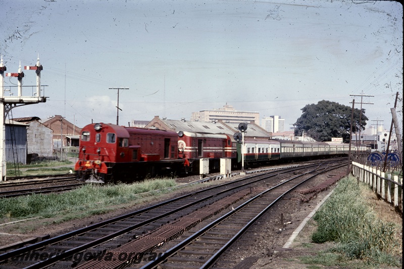 T05251
Ex MRWA F class 45 in red livery and another F class diesel in red livery with white stripes, double heading ARHS tour train, semaphore signals, light signals, trackside rodding, East Perth, ER line
