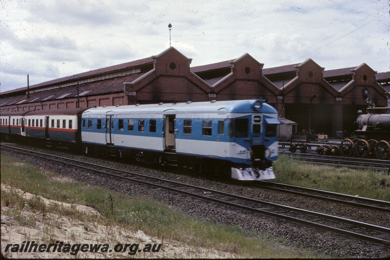 T05259
ADX class 670 railcar in blue and grey livery, ADA class trailer and AYE class trailer both in red white and green livery, loco sheds, East Perth, ER line, side and front view
