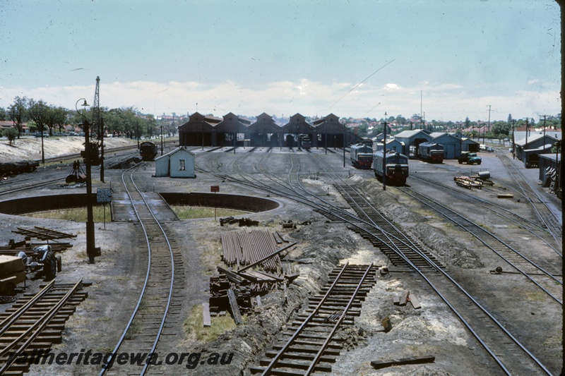 T05262
Overview of East Perth loco depot, steam locos, XA class diesel, two X class diesels, crane, pit, turntable, sheds, trackside buildings, East Perth, ER line
