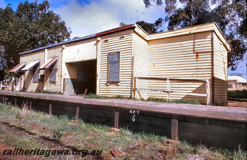 T05304
Derelict station building, windows with awnings and shutters, platform, Grass Valley, EGR line, view from ground level 
