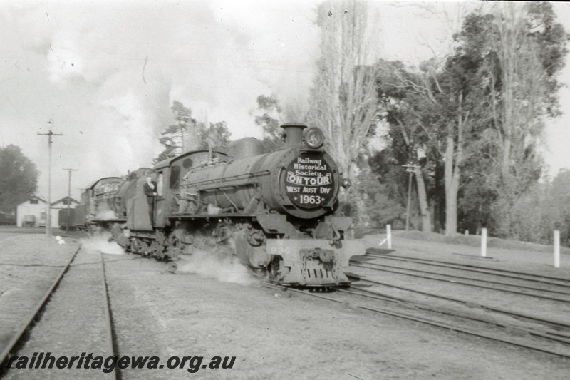 T05380
W class loco on Australian Railway Historical Society tour train, shed, tracks, rural setting, side and front view
