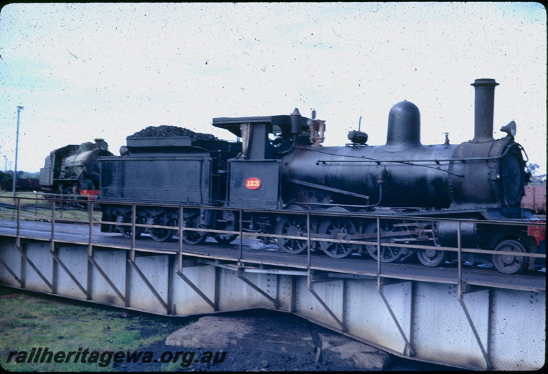 T06034
G Class 123, Collie loco depot, being turned on turntable, unidentified W Class in background
