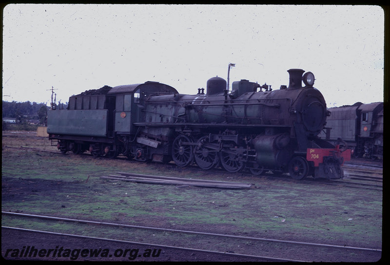 T06118
PM Class 704, stabled on turntable fan, Collie loco depot, V Class 1203 in background
