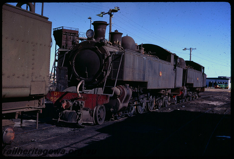 T06138
DD Class 595, DM Class 582, East Perth loco depot, coaling tower, unidentified X Class diesel locomotive at railcar depot in background
