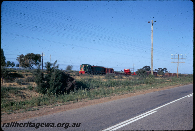T06258
A Class 1504 on goods train on narrow gauge EGR line running parallel to new standard gauge line, east of Kellerberrin, Great Eastern Highway in foreground
