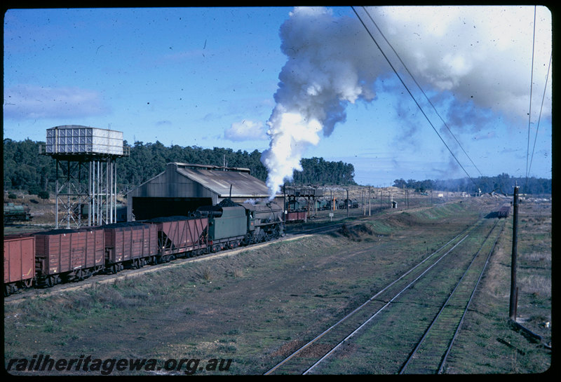 T06484
V Class 1203, loaded coal train departing Collie, XA Class coal wagon, GH Class coal wagons, water tank, running shed, BN Line
