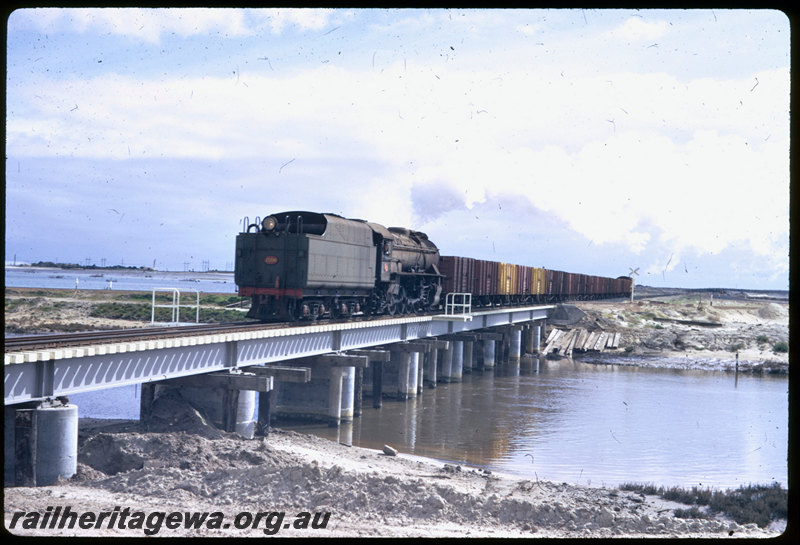 T06553
V Class 1206, empty coal train, returning from Bunbury Powerhouse, tender first, crossing Preston River Bridge, new Bunbury Inner Harbour in background
