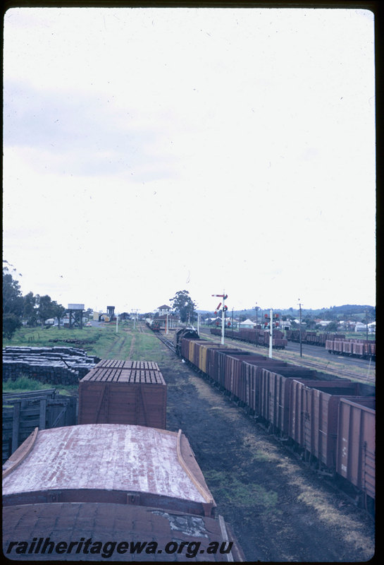 T06557
V Class 1206, empty coal train, tender first, arriving at Bruswick Junction from Bunbury, semaphore signals, station building, signal cabin, unidentified F Class on goods train in background, SWR line
