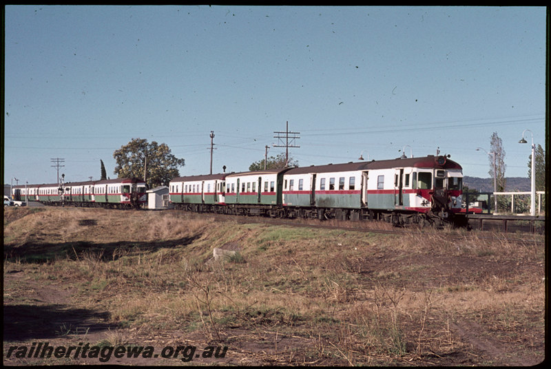 T06896
ADG/AYE/ADG Class railcar set, Down suburban passenger service, ADG/ADA/ADG/ADA Class railcar set, Up suburban passenger service, both trains arriving at Stokely, Albany Highway level crossing, SWR line
