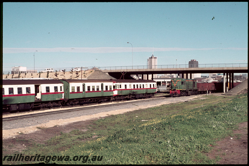 T07003
ADG/AYE/ADG Class railcar set, Down suburban passenger service, RA Class 1903, propelling loaded coal train into East Perth Power Station transfer sidings, GH Class wagons, East Parade overpass, SWR line
