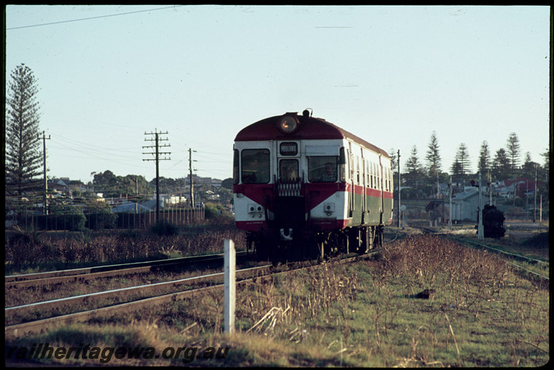 T07074
Single ADG Class railcar, Down suburban passenger service, departing Cottesloe, spur to Thomas Flour Mill on the right, semaphore signals, goods shed, ER line
