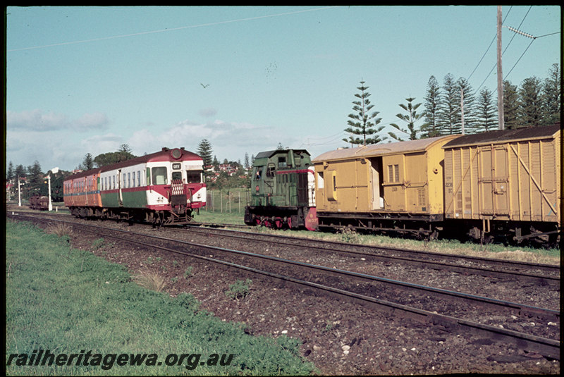 T07180
ADA Class trailer with ADG Class 605 railcar, first iteration of the Westrail livery, without white stripe, departing Cottesloe, Down suburban passenger service, B Class 1607, propelling grain wagons on spur towards Thomas Flour Mill spur, Z Class 559 brakevan, DC Class bulk grain wagon, ER line
