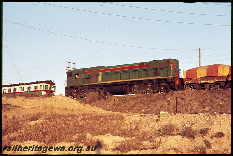 T07223
D Class 1562, Down goods train, GMD Class 15490 wagon, ADG Class railcar, Up suburban passenger service, between Leighton and Victoria Street, freight line from Leighton Yard to Cottesloe in cutting in foreground, ER line
