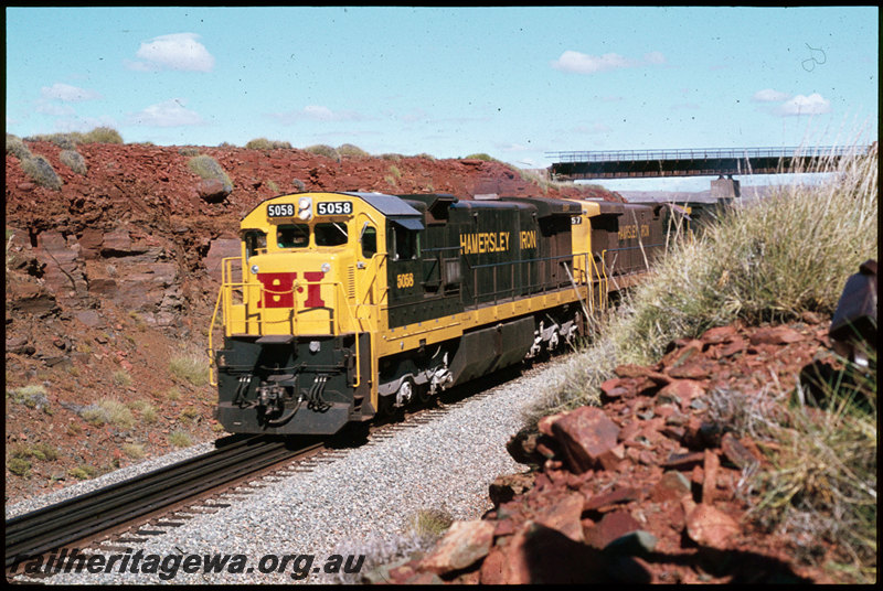 T07299
Hamersley Iron GE C36-7 5058 and 5057 with an unidentified ALCo C636 loco, loaded train iron ore train, passing under Robe River line, Western Creek, Pilbara
