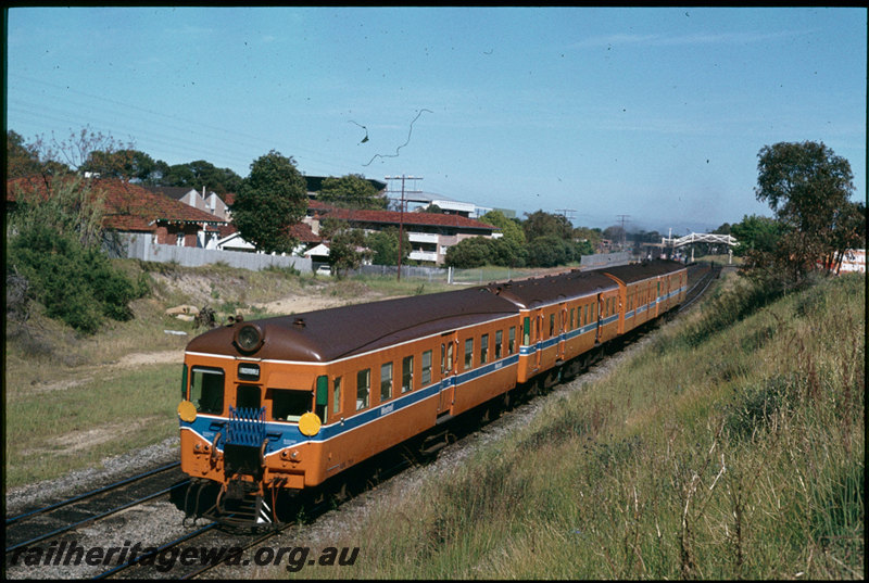 T07323
ADA/ADX/AYE/ADX Class railcar set, Down Show Special suburban passenger service, note yellow discs on lead vehicle indicating Show Special, West Leederville, footbridge, Perth Royal Show week, ER line
