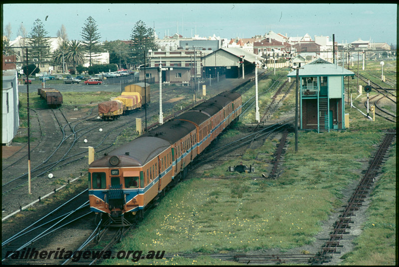 T07415
ADA/ADG/AYE/ADG/ADA/ADG Class railcar set, Down suburban passenger service, departing Fremantle, platform, station building, Fremantle Box B signal cabin, point rodding, semaphore signals, searchlight signals, footbridge, ER line
