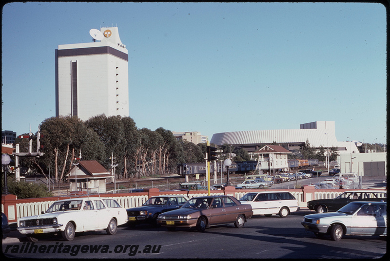 T08463
View from Horseshoe Bridge over Perth Yard, unidentified XA Class departing on an Up suburban passenger service, a 5-car set of hired Queensland Railways (QR) SXV and SX Class carriages, linen store, semaphore signals, Perth Box C signal cabin, ER line
